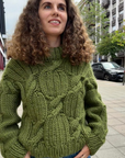 Cozy oversized olive green cable-knit pullover sweater in a street style look
